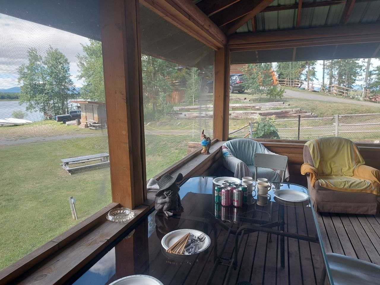 Community members grilling at a screened-in lakeside BBQ house at Lifechanyuan's Canada resort home, ...